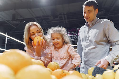 Family Buying Fresh Orange