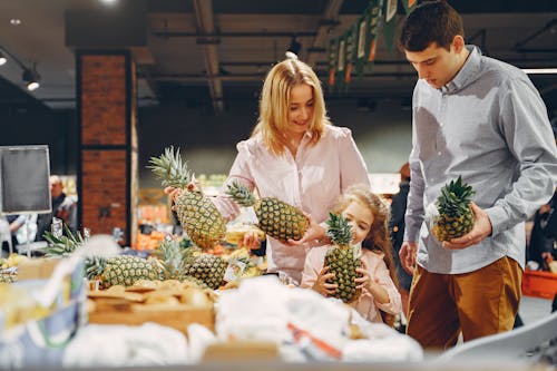 Family Buying Fresh Pineapples