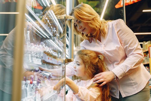 Mother Buying Her Daughter a Bottle Drink