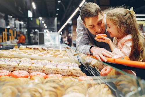 Father and Daughter Eating Donut