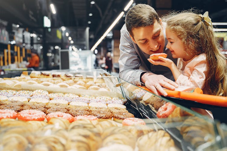 Father And Daughter Eating Donut