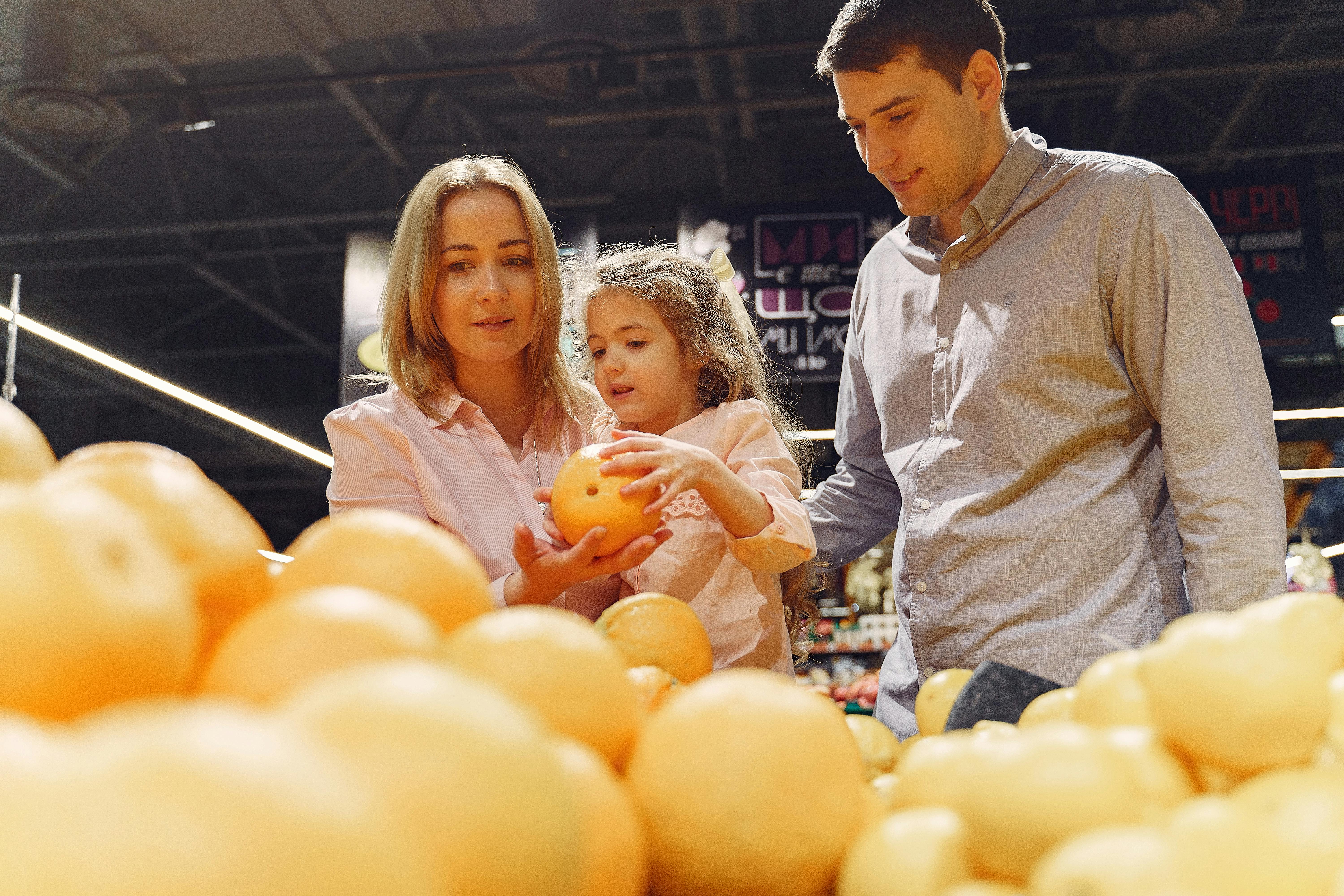 family buying fresh fruits