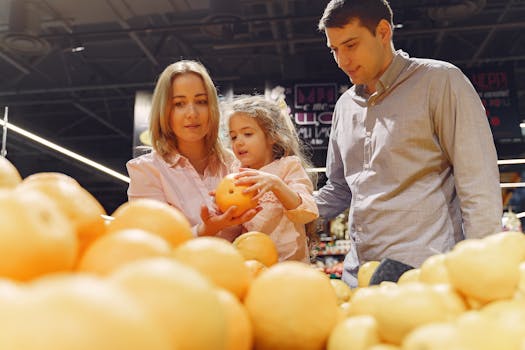 Parents and child selecting fresh oranges together at the supermarket. Captures family bonding and healthy shopping.