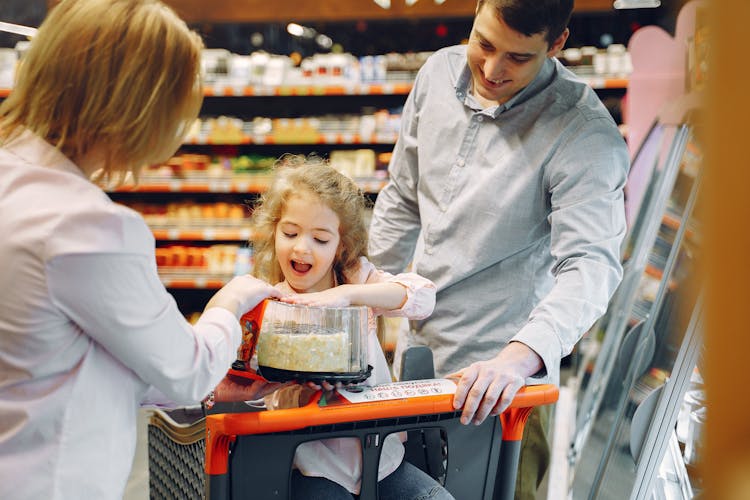 Happy Little Kid Buying A Cake