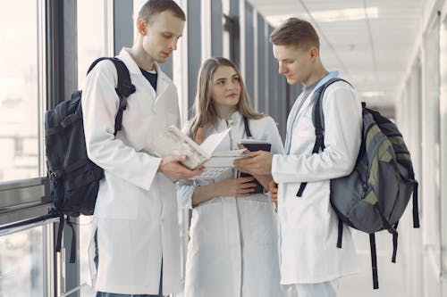 Free Group of Medical Students at the Hallway Sharing Notes Stock Photo