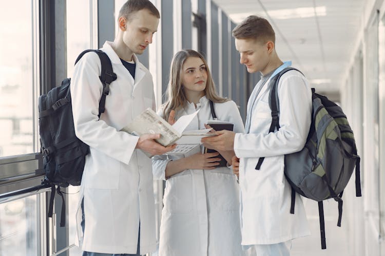 Group Of Medical Students At The Hallway Sharing Notes