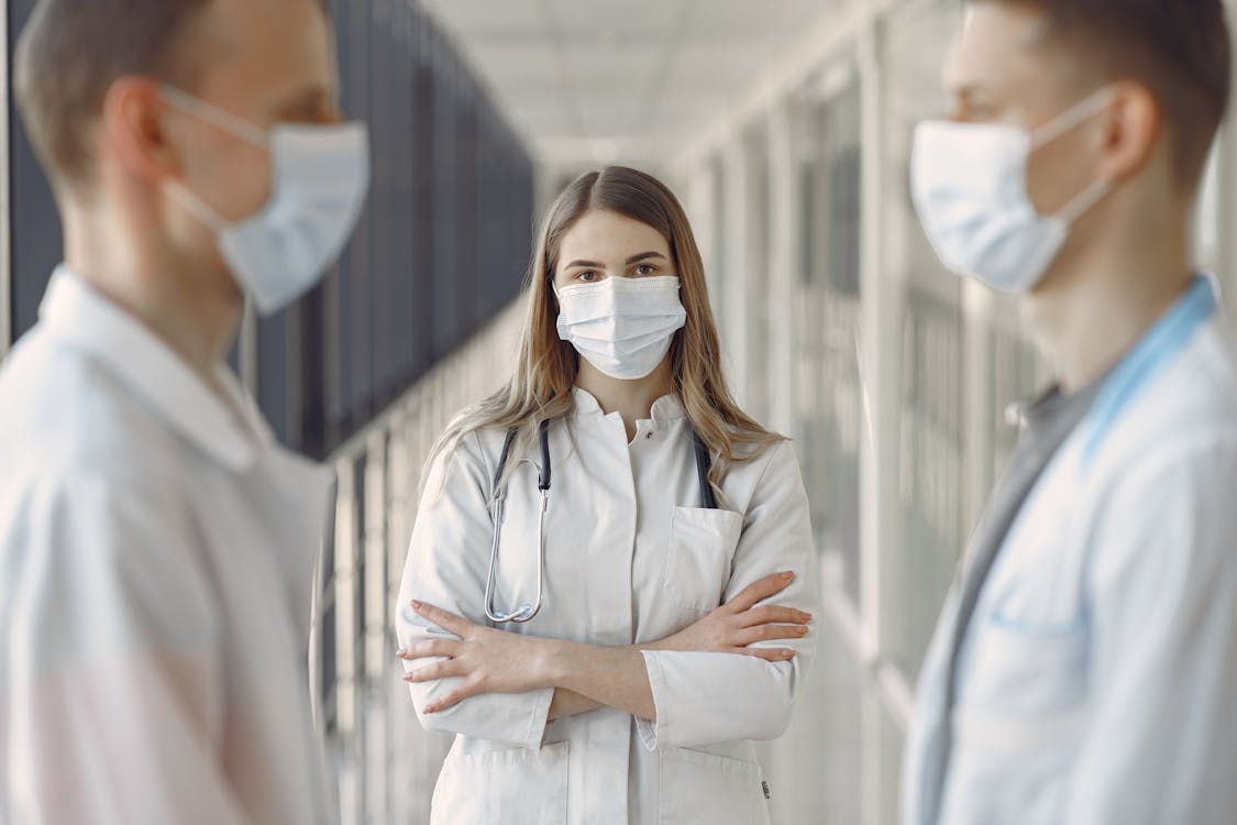 Free Woman in White Coat Wearing White Face Mask Stock Photo