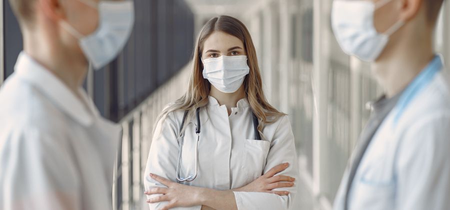Group of young medical students in lab coats studying together