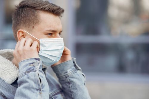 Free Close-up of a man outdoors wearing a face mask for personal protection and prevention. Stock Photo