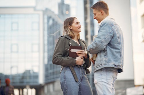 Free Man in Blue Denim Jacket and Woman in Gray Coat Stock Photo