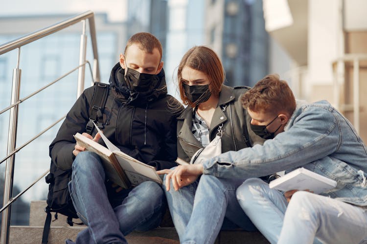 Students In Face Masks Reading Books During COVID 19