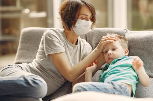 Free Mother Checking His Son if He Has Fever Stock Photo