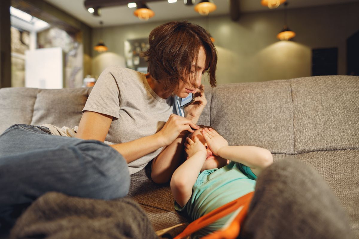 Mother calling her child's doctor for guidance from home