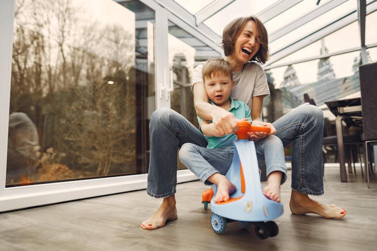 Mother And Son Riding A Twist Car