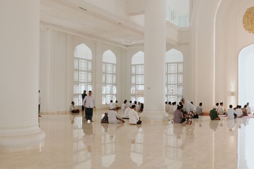 Free A serene scene of men gathered for prayer inside a spacious mosque in West Java, Indonesia. Stock Photo