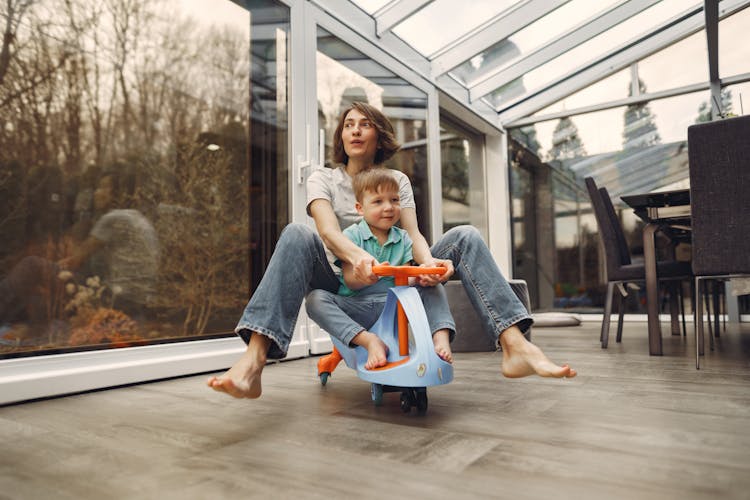 Mother And Son Riding A Twist Car