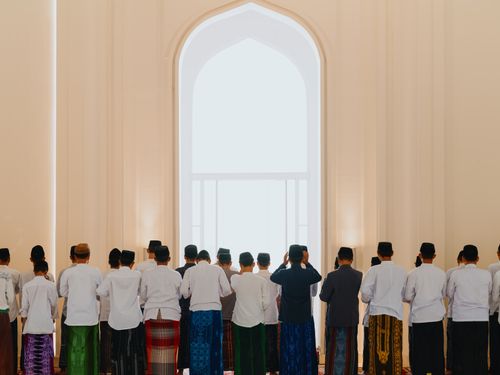 Free A group of men in traditional attire participating in prayer inside a mosque in West Java, Indonesia. Stock Photo