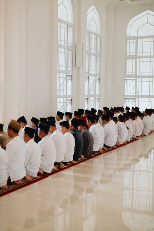 Free A group of men in traditional attire praying inside a mosque with beautiful architecture in West Java, Indonesia. Stock Photo