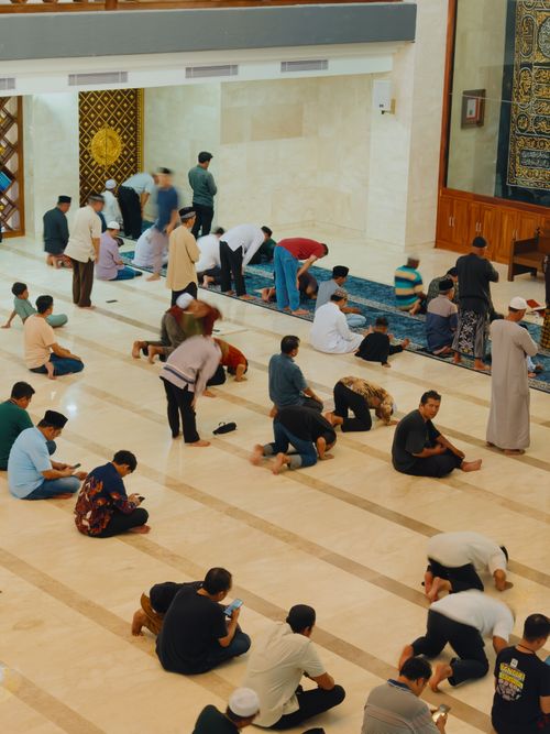 Free People engaged in prayer inside a mosque in Jawa Barat, Indonesia. Stock Photo