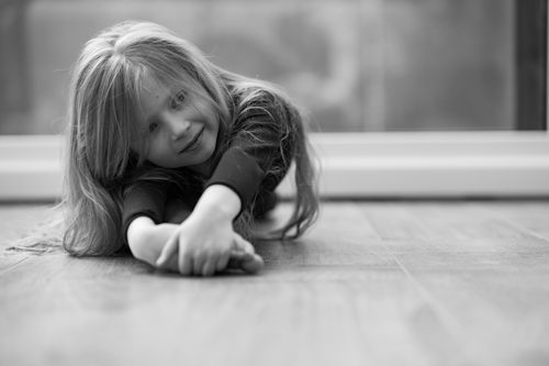 Free Charming black and white portrait of a young girl smiling indoors, showcasing innocence and joy. Stock Photo