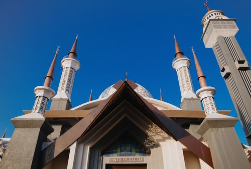 Free Stunning view of a mosque with tall minarets against a blue sky in Jawa Barat, Indonesia. Stock Photo
