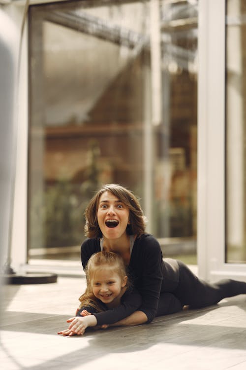 Free Mother and Daughter Lying on the Floor Stock Photo