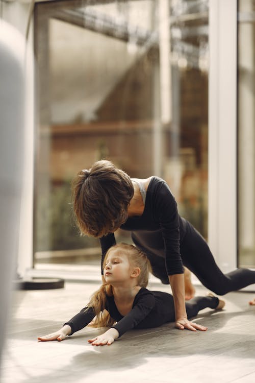 Little Girl Stands In One Of The Yoga Poses Stock Photo, Picture