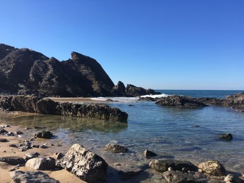 Free Serene view of rocky formations and clear waters on Portugal's Silver Coast under a clear blue sky. Stock Photo