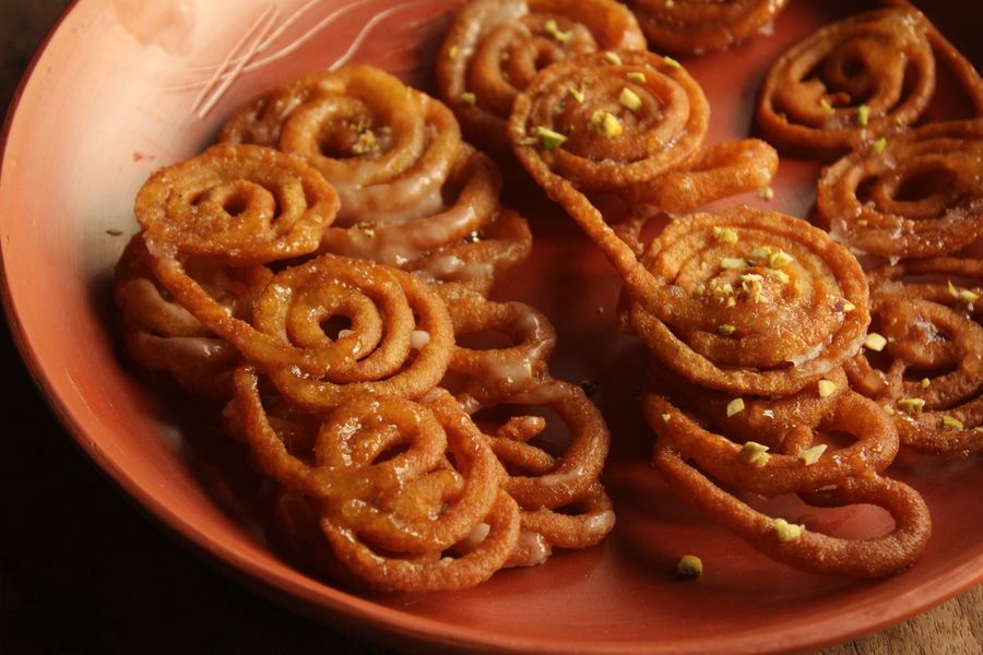 Spiral jalebi on a traditional clay dish