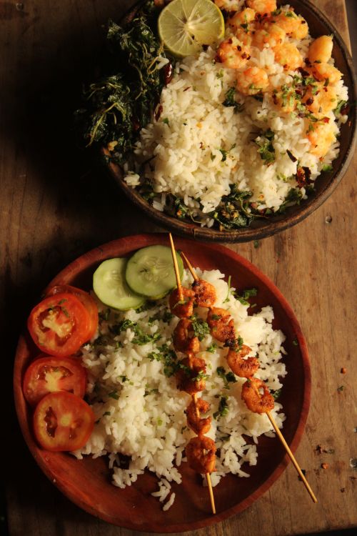 Free Tasty rice served with juicy shrimp skewers, fresh vegetables, and herbs. Stock Photo