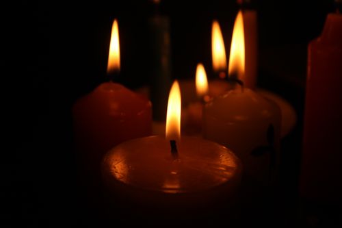 Free Multiple candles creating a warm and peaceful atmosphere in low light. Stock Photo