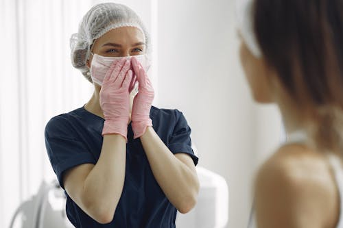 Woman in Blue Scrub Suit Feeling Happy