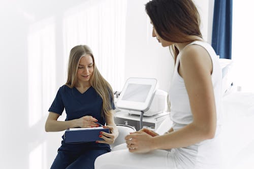Free Photo Of Woman Talking To The Sick Patient Stock Photo