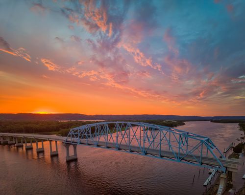 Free Stunning aerial view of the Wabasha Bridge at sunset with vibrant skies over the Mississippi River. Stock Photo