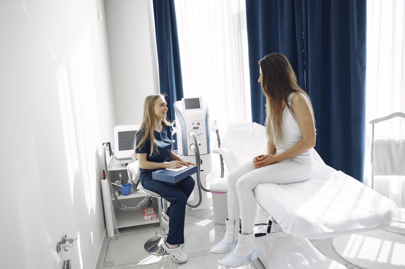 Woman speaking with a healthcare professional in a bright clinical setting
