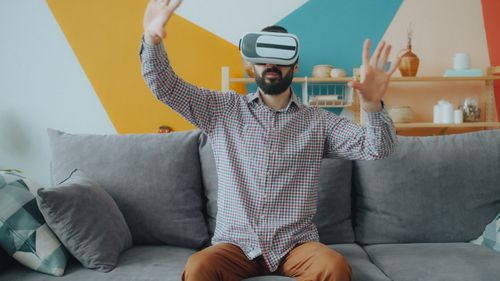 Free Adult male using VR headset, engaging with virtual reality indoors. Stock Photo