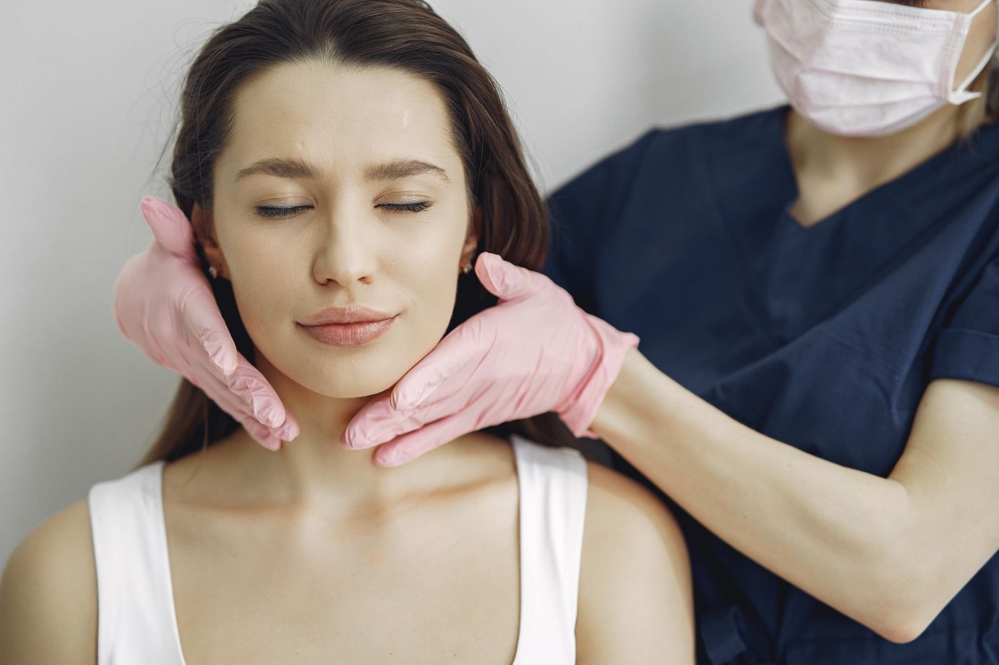 A relaxed client receiving a gentle facial massage