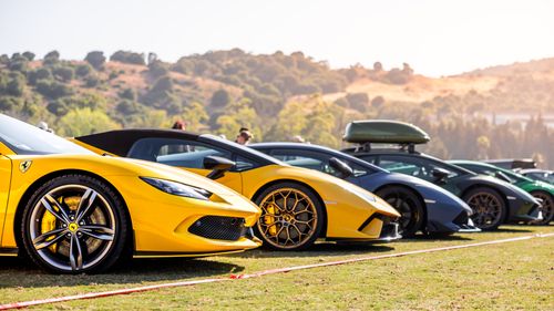 Free A row of bright luxury sports cars parked outdoors during the day. Stock Photo