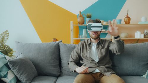 Free A man with virtual reality headset explores an interactive world indoors. Stock Photo