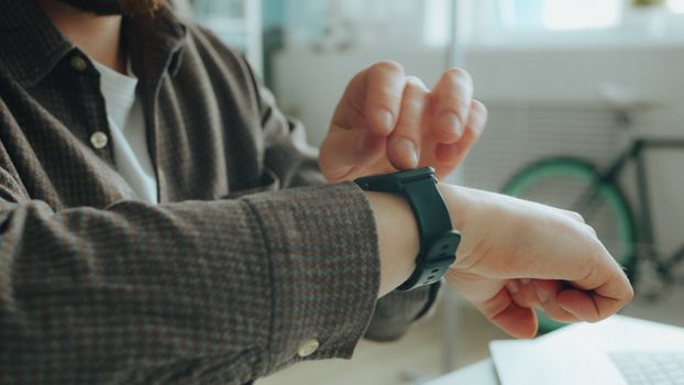 A person wearing a smartwatch-style device for continuous electrolyte monitoring.