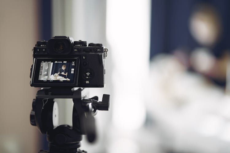 Photo Camera With Picture Of Cosmetologist Applying Mask To Client