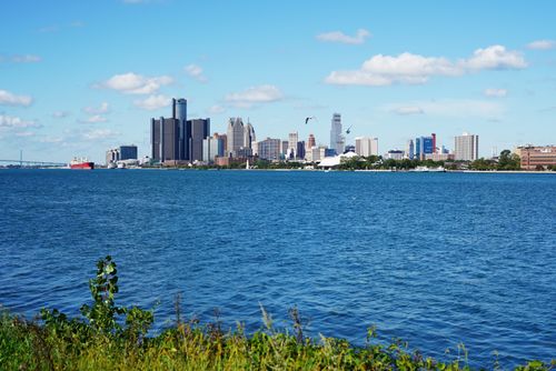 Free Stunning view of Detroit skyline with clear blue skies and tranquil river. Stock Photo