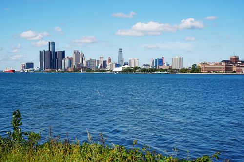 Free Panoramic view of Detroit skyline across the river, showcasing iconic buildings on a sunny summer day. Stock Photo