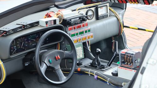 Free Inside view of a retro-futuristic car dashboard filled with electronics and gauges. Stock Photo