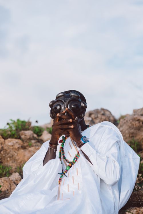 Free A man in traditional attire wearing a gas mask for a conceptual outdoor photo. Stock Photo