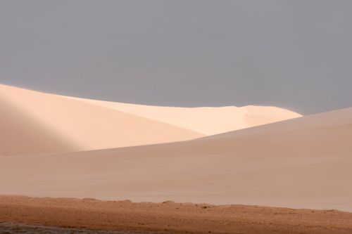 Free Calm and expansive sand dunes under a clear sky in Maranhão, Brazil. Stock Photo