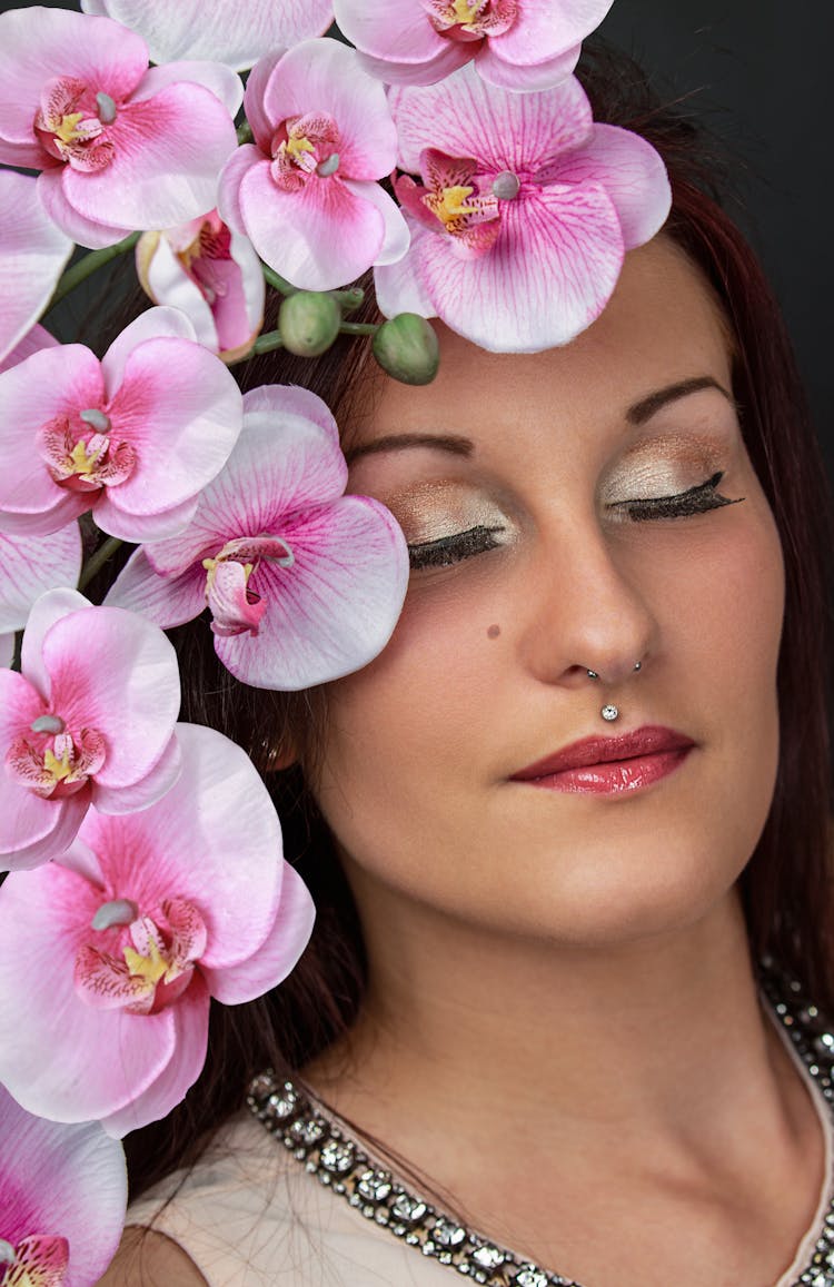 Close Up Of A Woman With Pink Orchids