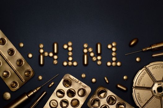 Gold-coated pills and blister packs forming H1N1 on a black surface, symbolizing healthcare and medication.