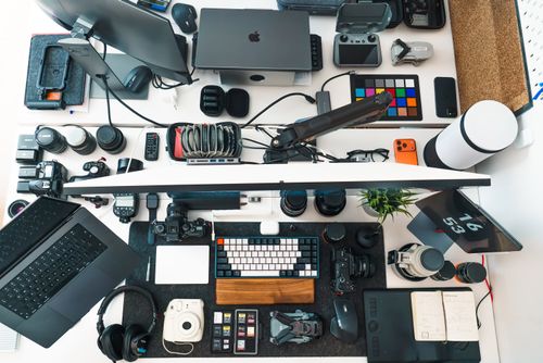 Free Top view of a well-organized photography and editing workspace with various equipment. Stock Photo