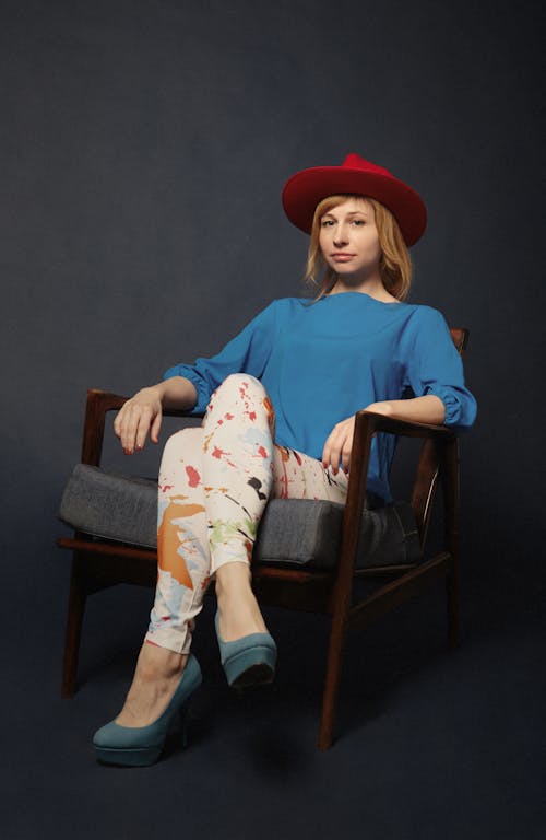 Woman Sitting On Brown Wooden Armchair